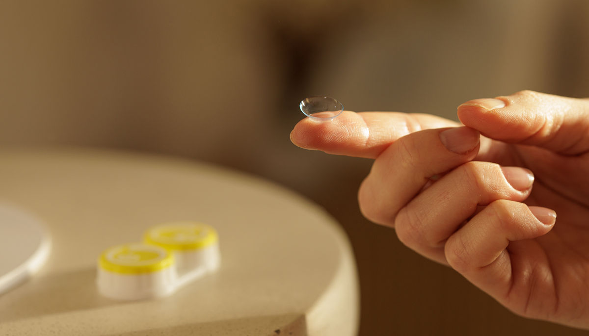 contact-lens contact lens on finger
